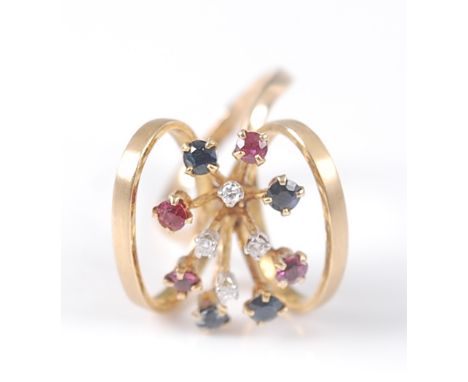 A yellow metal multi-stone ruby, sapphire and diamond spray ring, the ring having four round faceted rubies, four sapphires, 