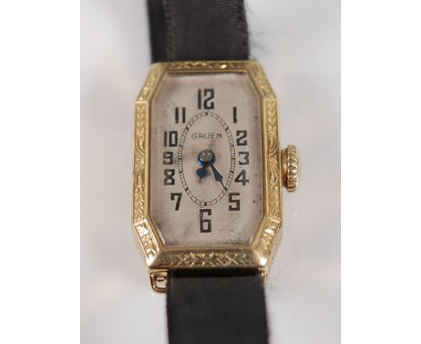 An Art Deco lady's Gruen Cincinnati 14ct gold cased tank watch, having a signed silvered dial, the case with leaf and flower 