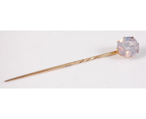 A yellow metal sapphire stick pin, the oval sapphire measuring approx 10.5 x 9.12 x 4.65mm, weight estimated as 3.94 carats, 