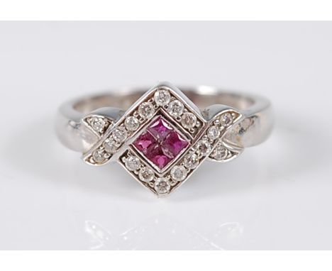 A 9ct white gold crossover style ruby and diamond square cluster ring, featuring a centre panel of four square cut rubies in 