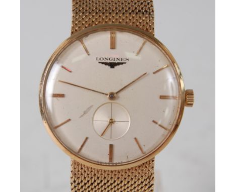 A 9ct yellow gold Longines Gents manual wind wristwatch, having a round champagne baton dial with subsidiary seconds dial at 