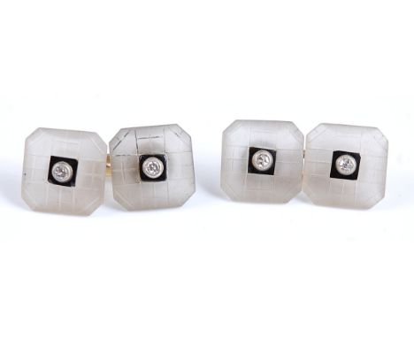 A pair of double ended cuff links , each with two octagonal carved chalcedony plates with black enamel centre set with a sing