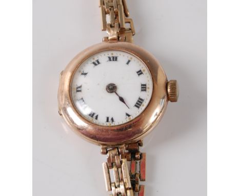 A lady's 9ct yellow gold Rolex manual wind wristwatch, the round white enamel Roman dial fitted to a rolled gold three bargat