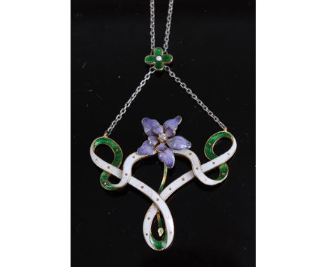 A circa 1900 yellow metal and enamelled openwork pendant in Suffragette colours, set with a centre lilac flower head, with cl