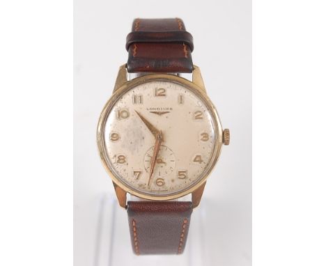 A gents 9ct yellow gold Longines 17 jewel manual wind wristwatch, with round champagne Arabic dial with subsidiary seconds at
