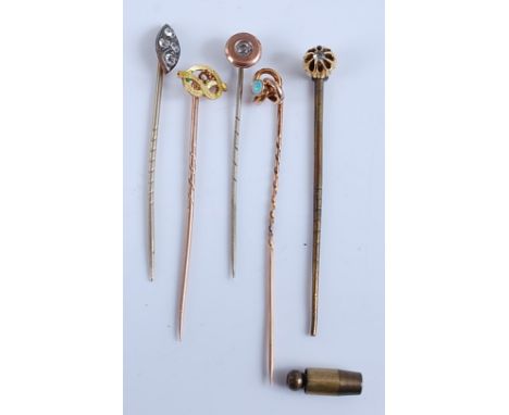 A collection of five yellow metal stick pins, comprising two base metal set with paste stones, one stamped 15ct with 3.6mm op