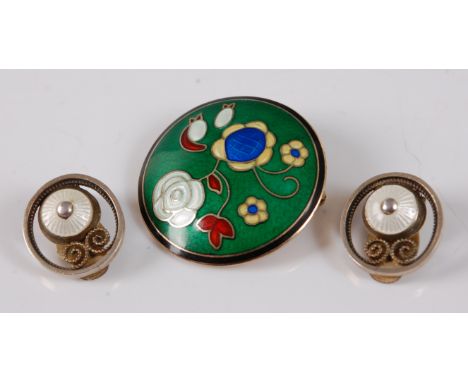 A contemporary Norwegian silver gilt and enamel set brooch, worked as flowers on a green ground, maker EM, dia. 29mm; togethe