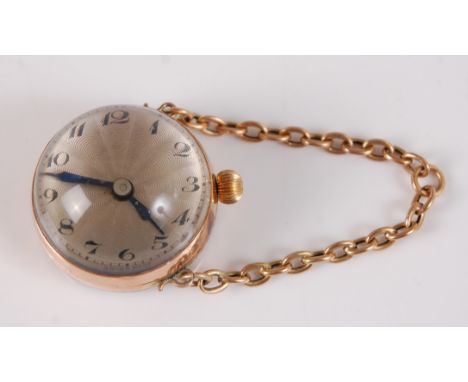 A Ladies yellow metal manual wind domed fob watch, having a round silver engine turned Arabic dial, with 60mm oval belcher li
