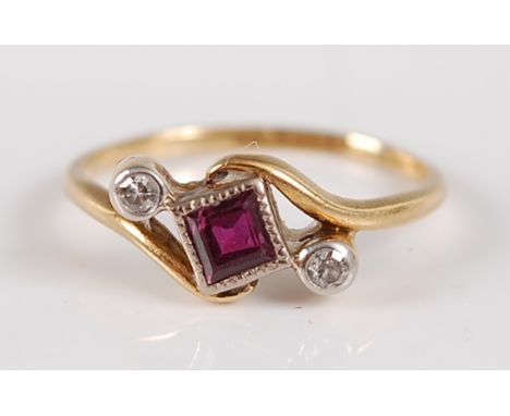 An Art Deco 18ct gold and platinum, ruby and diamond set ring, arranged as a centre rubover set square cut ruby flanked to ei