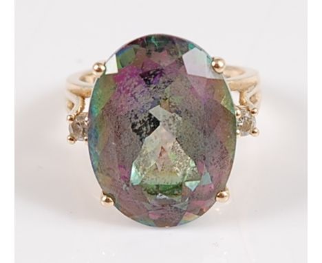 A yellow metal oval 'mystic topaz' and diamond dress ring, the topaz measuring approx 20.2 x 15.1 x 9.45mm, weight estimated 