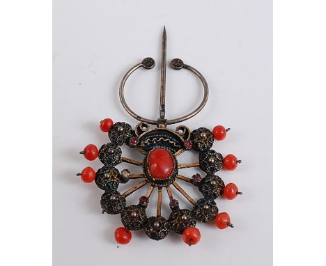 A fan shaped coral stick pin, with eleven filigree style spokes with 4mm coral bead terminals (two being deficient), and five