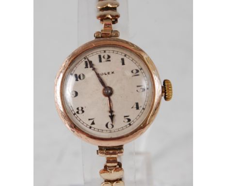 A lady's 9ct yellow gold Rolex manual wind wristwatch, the round silver engine turned Arabic dial with worn engraving around 