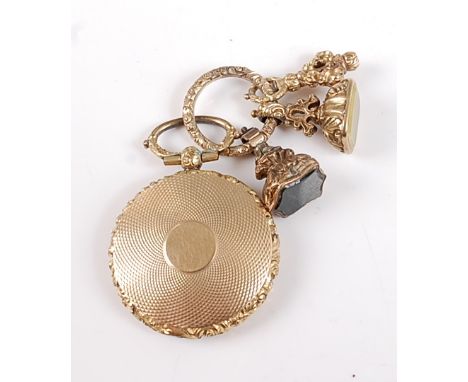 A yellow metal mourning pendant, the engine finished circular case with embossed floral detail to the edge, case opens to rev