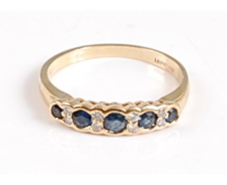 An 18ct yellow gold, sapphire and diamond half hoop eternity ring, the four round graduated sapphires measuring between appro