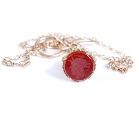 A 9ct yellow gold fob seal with a circular carnelian intaglio of a Roman head, the seal is attached to a 9ct gold oval tracel