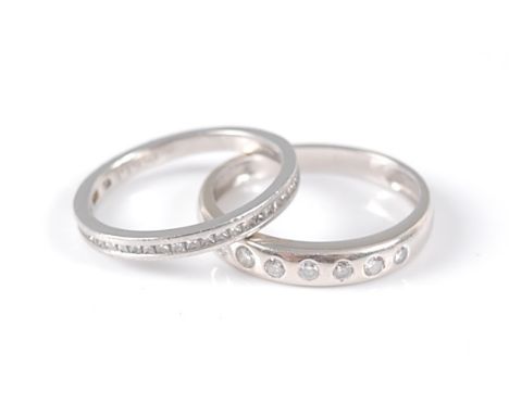 An 18ct white gold diamond set band ring, with seven round brilliant cut diamonds inset, diamond diameters between approx 1.6