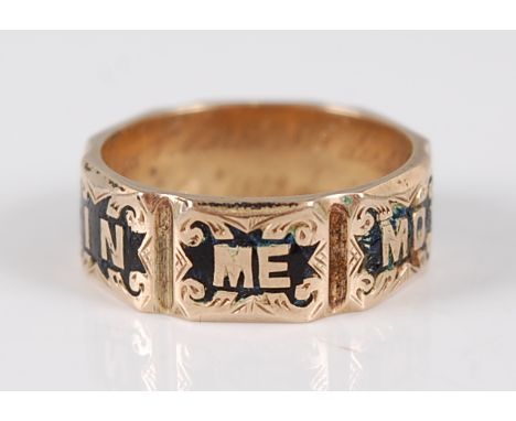 A Victorian yellow metal mourning ring, featuring engraved scrollwork detail with black enamel inlay and the words 'In Memory