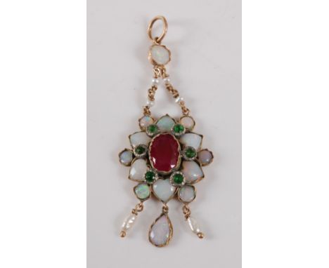 A 9ct yellow gold multi-stone flower pendant, featuring a centre oval faceted ruby within a border of six round green garnets