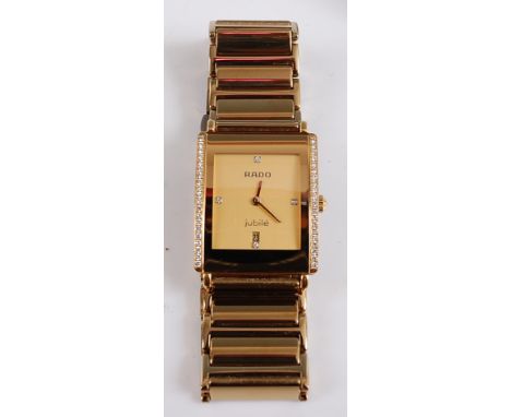 A Rado Diastar integral quartz wristwatch, the rectangular champagne dial with a diamond set at 12, 3, 6 and 9, and date aper
