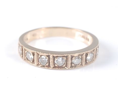 A 9ct yellow gold diamond half hoop eternity ring, comprising seven round brilliant cut diamonds in square millegrain setting