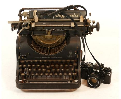 An Olympia Mod 8 manual typewriter, together with a Ricoh XR7 SLR camera with a Rikenon f/2 50mm lens and case. (2)