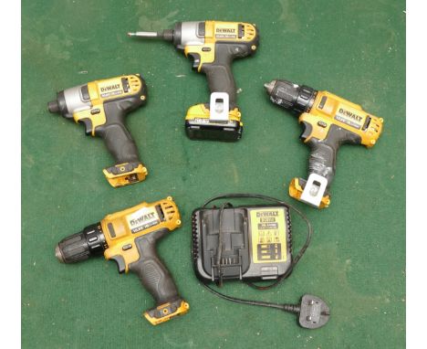 A collection of Dewalt cordless tools, including two impact drivers, two drills, one battery and one charger all 10.8V. Untes