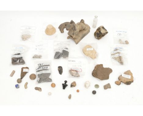 A collection of East Yorkshire archaeological finds, to include a Roman bronze mask 5.5cm, bronze age beads, Roman pottery an