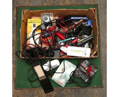 A box of diagnostic, charging and calibration tools including, a Gunson timing light.