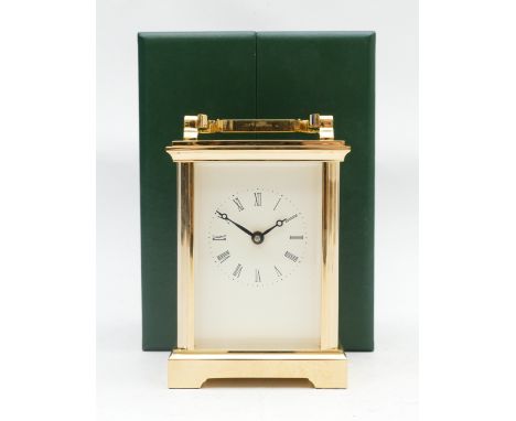 A DP English brass-cased carriage clock, with eight day movement, stamped eleven jewels, housed in a forest green presentatio
