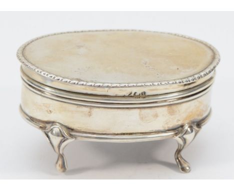 An oval silver trinket box, Birmingham 1909, with silk liner, raised on four feet, 8 x 5.5cm