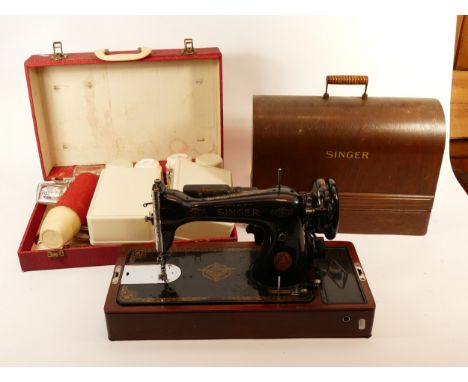 An early 20th century manual Singer sewing machine, together with a later electric example, both cased with a 1960s fitted pi