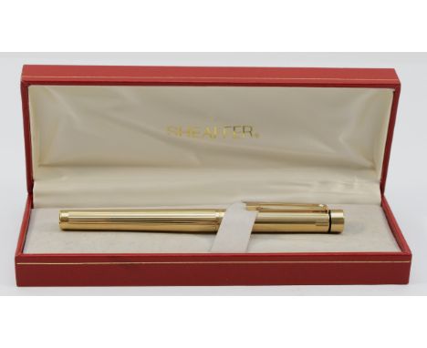 Sheaffer, a gold plated squeeze action fountain pen with 14K gold nib, case