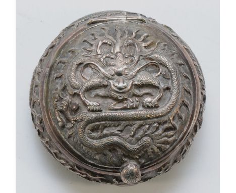 A Chinese apparently unmarked silver circular box, having embossed decoration of the Chinese Dragon, diameter 7cm, 62gm.