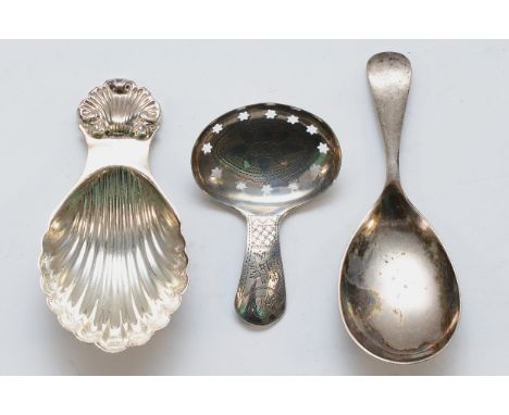 A George III bight cut silver pierced caddy spoon, Birmingham 1809 and two later examples, 45gm
