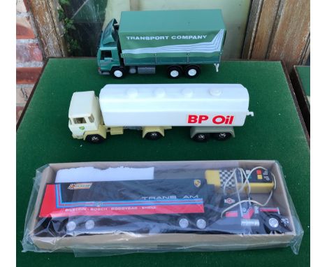 Three large plastic model trucks to include EmekMuovi Oy Finland 03870 Transport Company Truck Hammer Toys West Germany BP Oi