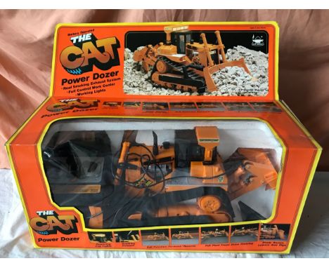 New Bright Scale Model No. 2191 battery operated/remote control 'The Cat' Bulldozer.Condition ReportBoxed, unused.