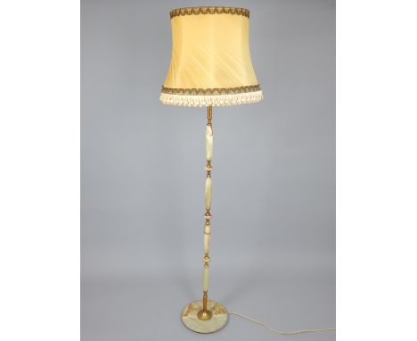 Gilt metal and onyx standard lamp and shade with sectional column and circular foot.