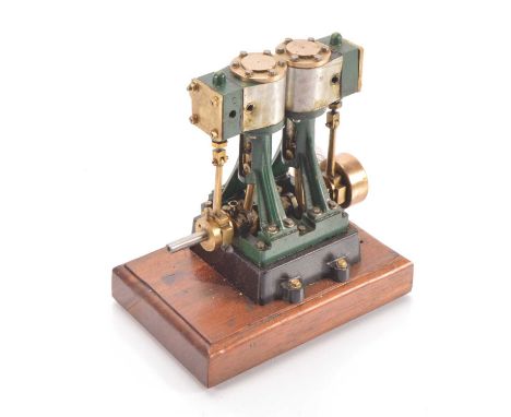 A neatly-made Stewart-Turner based twin-cylinder Vertical Steam Engine, finished in green and black with aluminium casings to