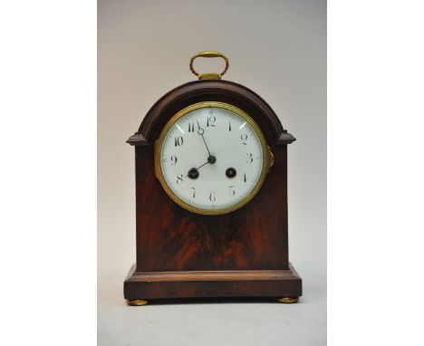 An Edwardian mahogany mantel clock the enamel dial with arabic nemerals