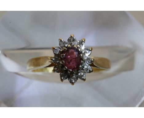 An 18ct gold ruby and diamond cluster ring