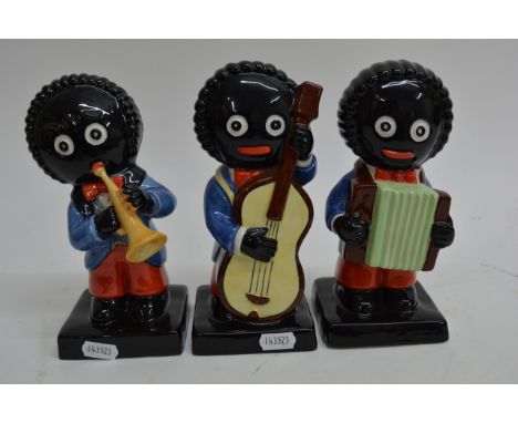 Three Carltonware golly musician figures comprising a double bass player 57/1000, trumpeteer 68/500 and an accordionist 71/10