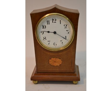 An inlaid mantle clock with sloped top
