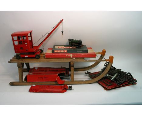 A vintage West German sled by Gloco, two vintage board games, Hornby O gauge train and track plus a Tri-ang crane.