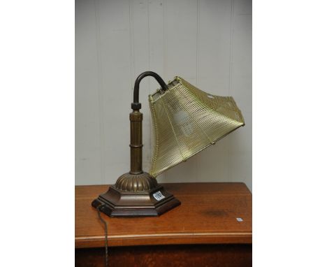 A brass table lamp with wire work shade.