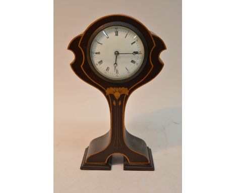 An Art Nouveau inlaid mantle clock of sinuous form
