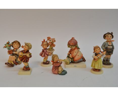 A collection of 17 Goebel Hummel figures of children.
