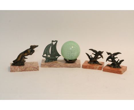 A circa 1950's table light mounted with a ship, a pair of Deco style bookends and a greyhound figure (4).
