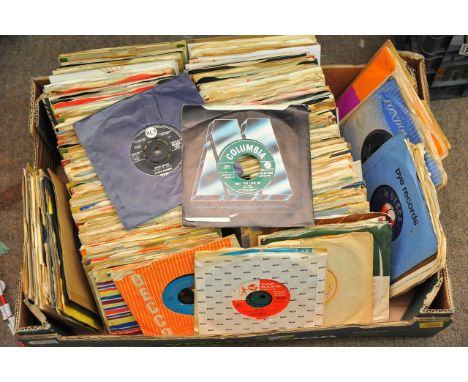 A box containing a collection of 1950s - 60s 45rpm records including The Kinks, Bob Dylan, Elvis etc