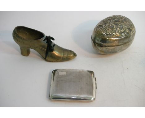 A silver cigarette holder, an embossed egg shaped holder and a brass shoe