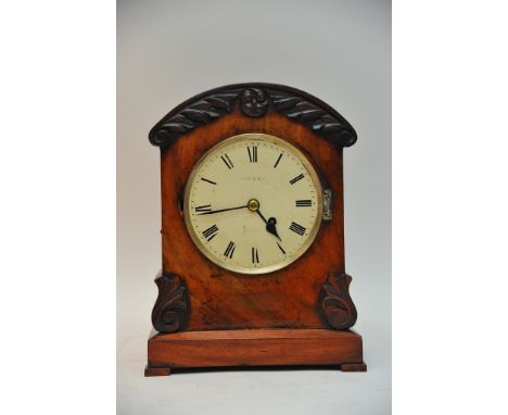 A William IV mahogany mantel clock, the circular dial with Roman numerals